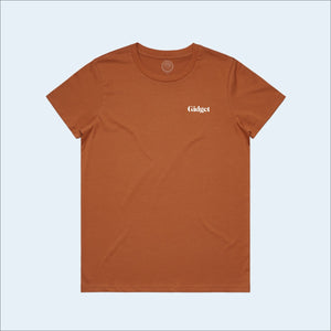 Women's copper colored t-shirt, view of front-side, with small print of g-fin logo